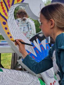 girl painting a swan