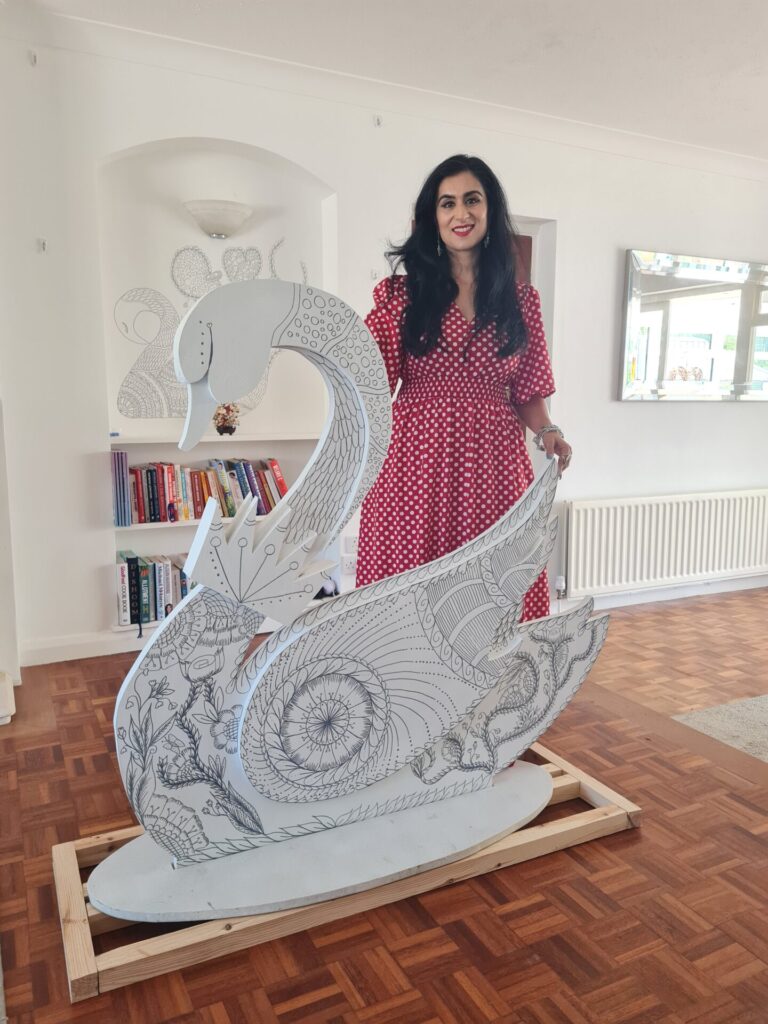 photo of a artist and swan sculpture