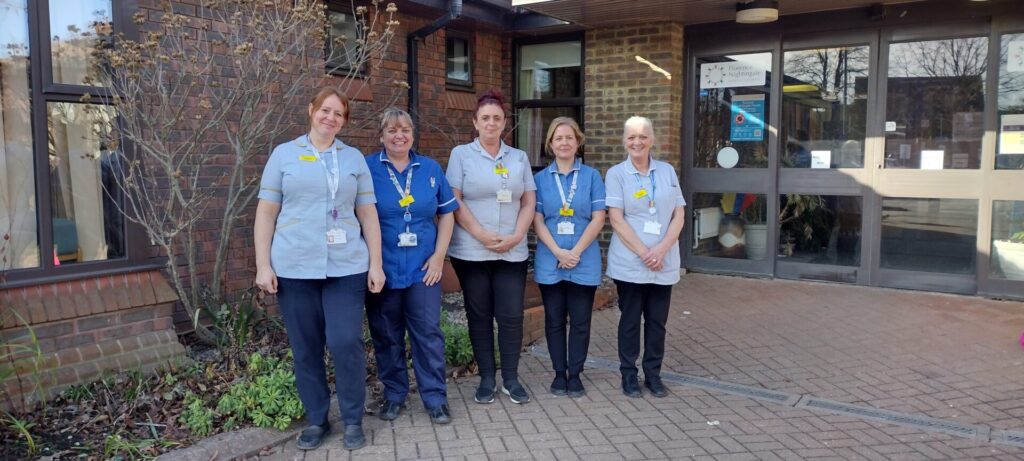 image shows a team of nurses outside a hospice