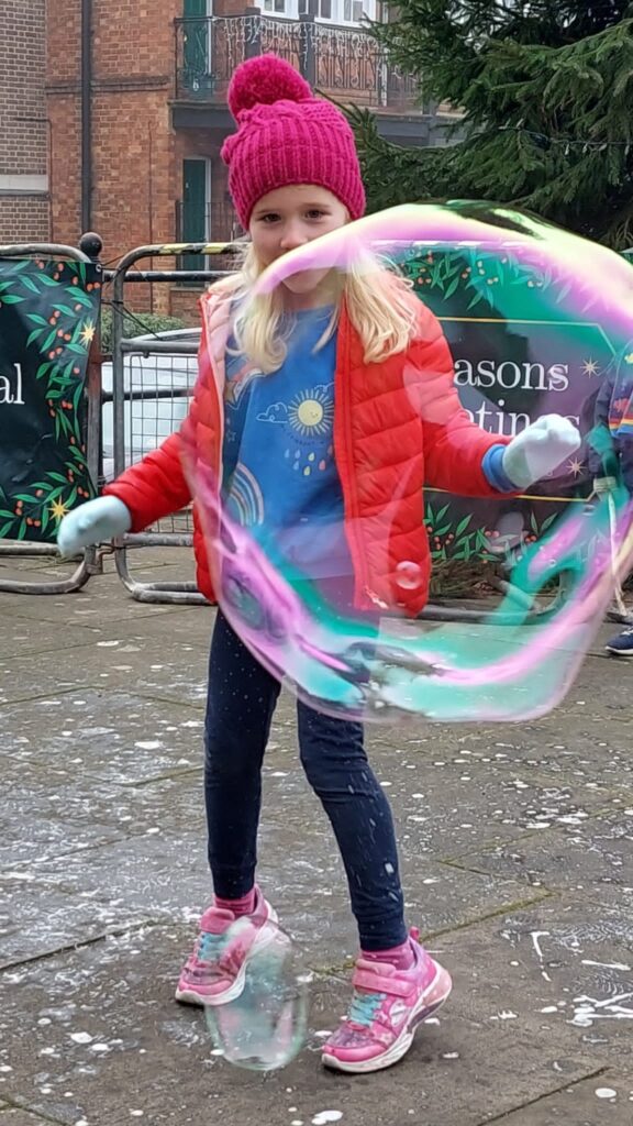 photo of a girl and a giant bubble