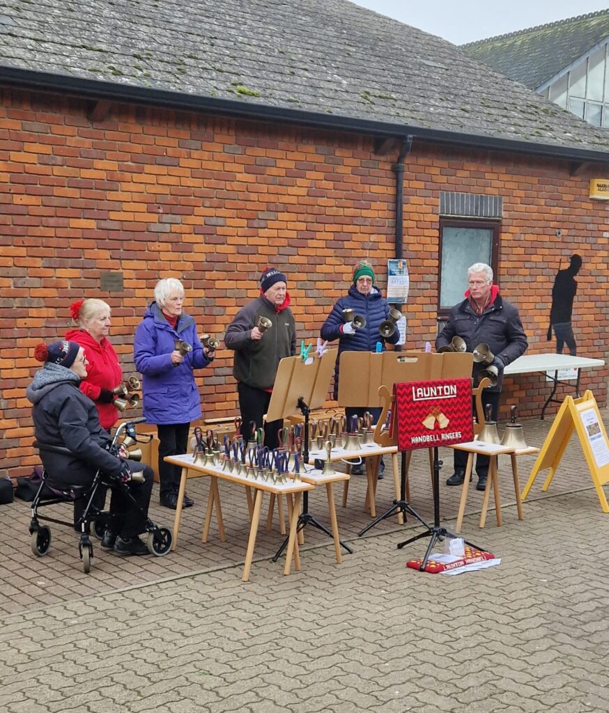 photo of a group of people ringing hand bells